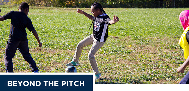 Beyond the pitch newsletter header image of girl with ball on field